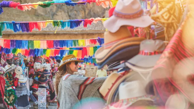 female traveler shopping in colorful Peruvian market